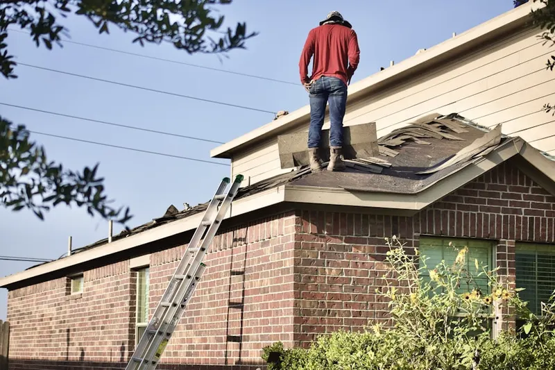 Professional roofer working on a residential roof in Morral